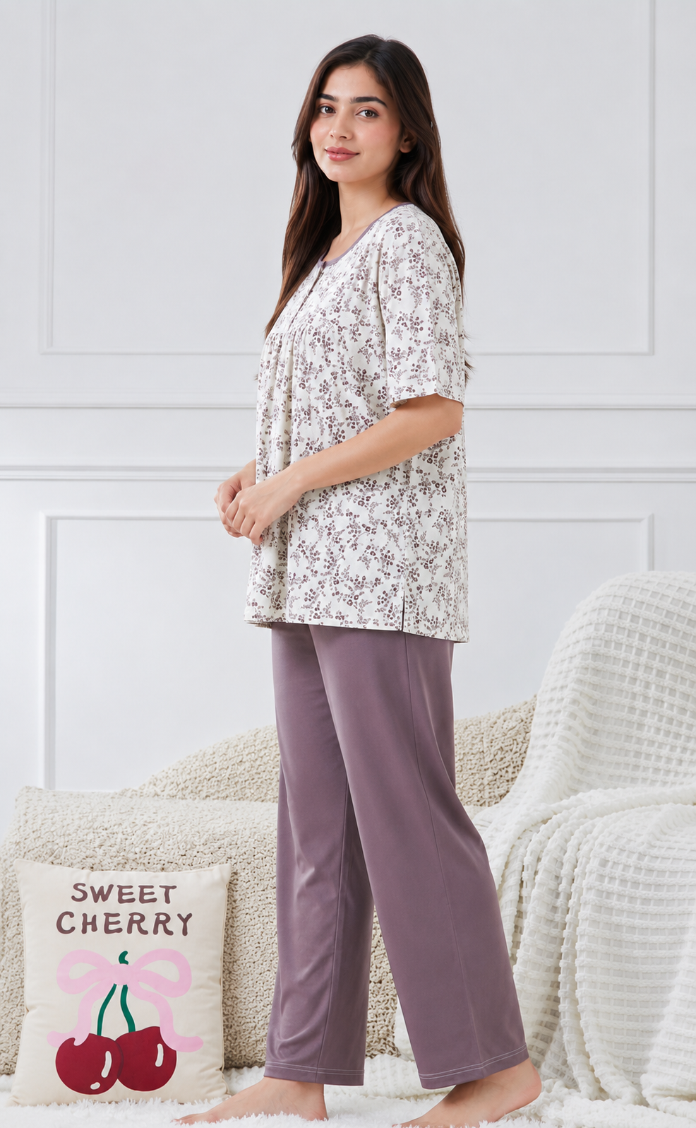 Woman wearing a floral top and purple pants 