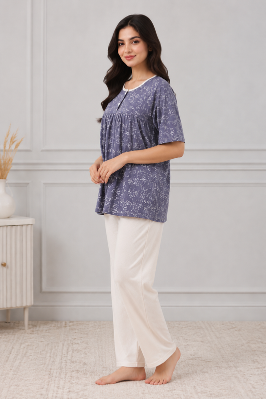 Woman wearing a blue patterned top and white pants
